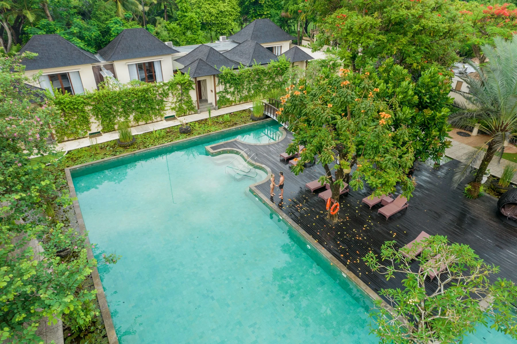 A tropical resort pool surrounded by greenery in Bali